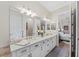 Bright bathroom with dual sinks and an expansive counter, complemented by decorative accents and neutral tones at 7044 Whittlebury Trl, Bradenton, FL 34202