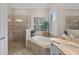 Elegant bathroom featuring a soaking tub with tile surround and a glass enclosed shower at 7044 Whittlebury Trl, Bradenton, FL 34202