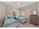 Cheerful bedroom featuring two twin beds with sea-themed decor and a ceiling fan at 7044 Whittlebury Trl, Bradenton, FL 34202