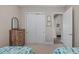 Neutral bedroom with closet, dresser, and serene views of the entryway at 7044 Whittlebury Trl, Bradenton, FL 34202