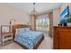Inviting bedroom with a woven bed frame, plantation shutters, and cozy bedside lamps at 7044 Whittlebury Trl, Bradenton, FL 34202