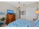 Cozy bedroom with a blue patterned bedspread and a decorative chandelier at 7044 Whittlebury Trl, Bradenton, FL 34202