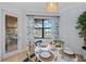 Bright breakfast nook featuring a view of the pool and an oval table with seating for four at 7044 Whittlebury Trl, Bradenton, FL 34202