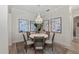 Stylish dining room with a round table, chandelier, and sophisticated artwork at 7044 Whittlebury Trl, Bradenton, FL 34202