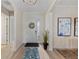 Bright foyer featuring a decorative rug, a glass-accented front door, and stylish decor at 7044 Whittlebury Trl, Bradenton, FL 34202