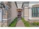 Inviting front entrance with stone accents, a decorated front door, and manicured landscaping at 7044 Whittlebury Trl, Bradenton, FL 34202