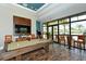 Spacious game room boasts a pool table, arcade games, and ample seating with bright windows at 7044 Whittlebury Trl, Bradenton, FL 34202