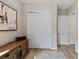 Hallway featuring a large closet with sliding doors, wood look tile floor, and a storage cabinet at 7044 Whittlebury Trl, Bradenton, FL 34202