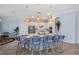 Kitchen island with breakfast bar and stylish pendant lighting, adjacent to modern appliances at 7044 Whittlebury Trl, Bradenton, FL 34202