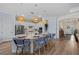 Modern kitchen island with stylish seating and pendant lighting, perfect for casual dining and socializing at 7044 Whittlebury Trl, Bradenton, FL 34202