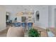 Kitchen island offers seating and a view into the dining area, featuring modern appliances and lighting at 7044 Whittlebury Trl, Bradenton, FL 34202