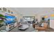 Bright living room features stylish decor, comfortable seating, and a view of the outdoor space and lake at 7044 Whittlebury Trl, Bradenton, FL 34202