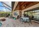 Outdoor patio with brick pavers, screened enclosure, patio furniture, and ceiling with wood accents at 7044 Whittlebury Trl, Bradenton, FL 34202