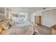 Light-filled main bedroom featuring a decorative quilt and spacious closet at 7069 W Country Club N Dr # 7069, Sarasota, FL 34243