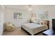 Well-lit bedroom featuring windows with blinds, neutral carpet, and simple, coastal decor at 7069 W Country Club N Dr # 7069, Sarasota, FL 34243