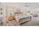 Well-lit bedroom with a bed, bedside tables with lamps, and a view to the outdoor landscape at 7069 W Country Club N Dr # 7069, Sarasota, FL 34243