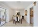 Bright dining room with tile floors, elegant lighting, and a view of the screened lanai at 7069 W Country Club N Dr # 7069, Sarasota, FL 34243