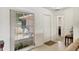 Bright entryway featuring tile floors, a large window with patio views, and ample closet space at 7069 W Country Club N Dr # 7069, Sarasota, FL 34243