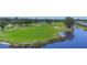 Scenic aerial view of a lush green golf course with mature trees and waterfront property at 7069 W Country Club N Dr # 7069, Sarasota, FL 34243