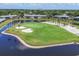Aerial view of green golf course with sand traps and ponds surrounded by mature trees at 7069 W Country Club N Dr # 7069, Sarasota, FL 34243