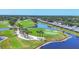 Scenic aerial view of a lush green golf course with water features surrounded by mature trees at 7069 W Country Club N Dr # 7069, Sarasota, FL 34243