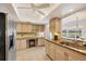 Kitchen with stone countertops, stainless steel refrigerator, built in desk and breakfast bar at 7069 W Country Club N Dr # 7069, Sarasota, FL 34243