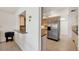 Galley kitchen features stone countertops, stainless steel refrigerator, and tile flooring at 7069 W Country Club N Dr # 7069, Sarasota, FL 34243