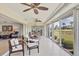 Expansive lanai with seating, ceiling fans, and serene views of the lake and golf course at 7069 W Country Club N Dr # 7069, Sarasota, FL 34243