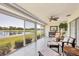 Bright sunroom with tile flooring and views of the lake and well-manicured landscaping at 7069 W Country Club N Dr # 7069, Sarasota, FL 34243