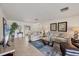 Spacious living room with tile flooring, comfortable seating, and plenty of natural light at 7069 W Country Club N Dr # 7069, Sarasota, FL 34243