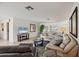 Bright living room featuring tile floors, neutral paint, and comfortable seating arrangement at 7069 W Country Club N Dr # 7069, Sarasota, FL 34243