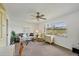 Cozy living room with water views, featuring comfortable seating, and neutral carpet flooring at 7069 W Country Club N Dr # 7069, Sarasota, FL 34243