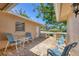 Charming covered patio with brick flooring, outdoor seating, and views of the lush surrounding greenery at 7069 W Country Club N Dr # 7069, Sarasota, FL 34243
