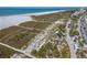 Aerial view of the beach featuring green grasses, shady pavilions and clear water at 717 Treasure Boat Way, Sarasota, FL 34242