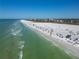 Aerial view showcasing beachgoers and the beautiful Gulf coast at 717 Treasure Boat Way, Sarasota, FL 34242