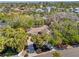 Aerial view of home showcasing a well-manicured lawn, charming architecture, and mature landscaping at 717 Treasure Boat Way, Sarasota, FL 34242