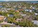 An aerial view showcases this homes waterfront community, lush landscaping, and location near the water at 717 Treasure Boat Way, Sarasota, FL 34242
