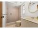 Cozy bathroom featuring a tiled walk-in shower, neutral color palette, and updated fixtures at 717 Treasure Boat Way, Sarasota, FL 34242