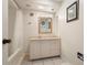 Bathroom featuring a tub with shower and vanity with ornate framed mirror at 717 Treasure Boat Way, Sarasota, FL 34242