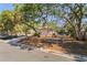 Charming single story home nestled among mature trees with a long driveway, offering shaded privacy at 717 Treasure Boat Way, Sarasota, FL 34242
