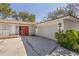 Charming home exterior featuring red double-doors, a two car garage, and attractive architectural details at 717 Treasure Boat Way, Sarasota, FL 34242