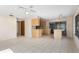 An open concept kitchen featuring tile floors, light wooden cabinets, and barstool seating for casual dining at 717 Treasure Boat Way, Sarasota, FL 34242