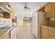 An eat in kitchen featuring modern appliances, tile flooring, a ceiling fan, and light colored wooden cabinets at 717 Treasure Boat Way, Sarasota, FL 34242