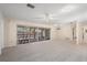 Spacious living room with neutral carpet, a ceiling fan, and sunroom access at 717 Treasure Boat Way, Sarasota, FL 34242