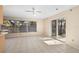 A bright and spacious living area boasting tile flooring, a ceiling fan, and natural light from the outdoor patio at 717 Treasure Boat Way, Sarasota, FL 34242