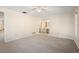 Main bedroom with neutral carpet, a ceiling fan, a heat/AC vent, and a view into the main bath at 717 Treasure Boat Way, Sarasota, FL 34242