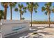 A sign for Siesta Beach with palm trees in the background and a clear blue sky at 717 Treasure Boat Way, Sarasota, FL 34242