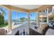 A covered patio shows lounge furniture beside a pool and scenic water views at 7342 Captain Kidd Ave, Sarasota, FL 34231