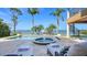 The backyard boasts a pool, hot tub, spiral staircase, and expansive water views at 7342 Captain Kidd Ave, Sarasota, FL 34231