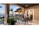 Serene balcony with outdoor seating, offering a picturesque view of the waterfront and tropical foliage at 7342 Captain Kidd Ave, Sarasota, FL 34231
